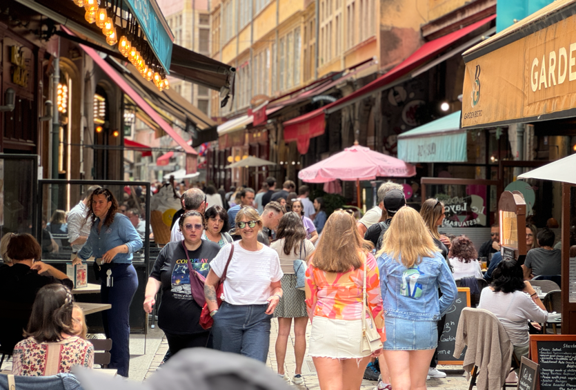 A group of people walking down a street

Description automatically generated